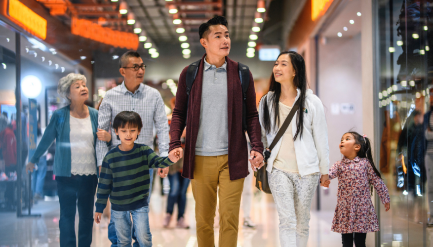 A family walking through a shopping centre.