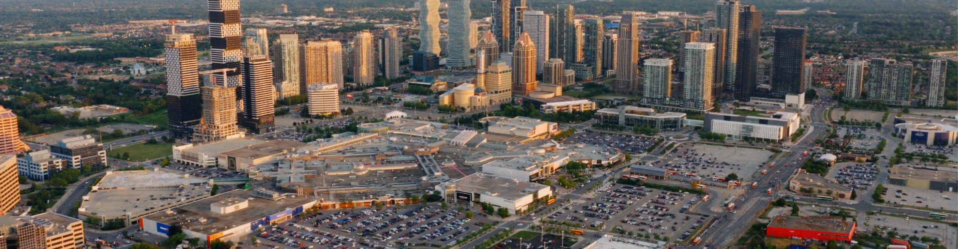 Expansive city skyline highlighting a major shopping centre within a dense and active urban setting