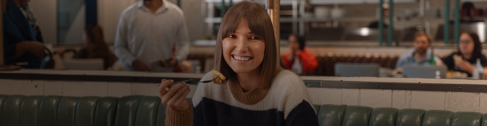 Woman dining at a restaurant inside the mall enjoying a relaxed and casual dining experience
