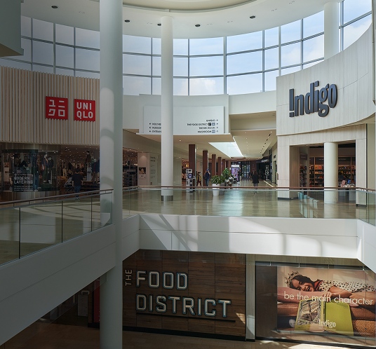 Mall interior with Indigo storefront along a spacious and well-lit shopping walkway