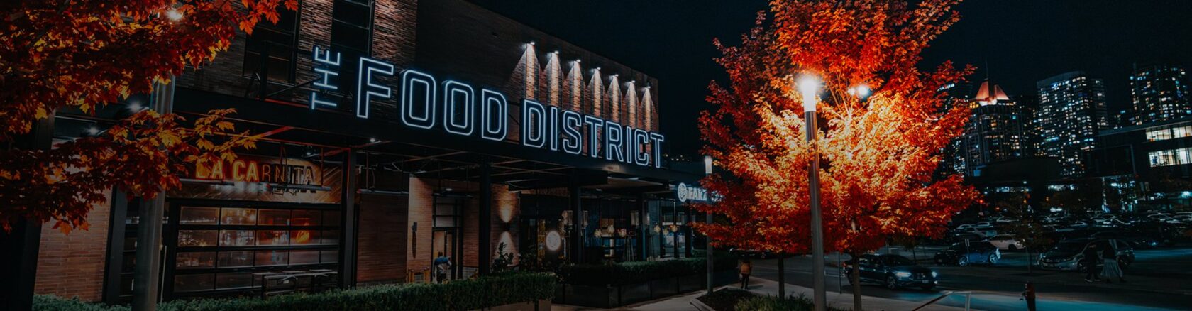 Food district lit at night with restaurants offering a vibrant and lively dining atmosphere
