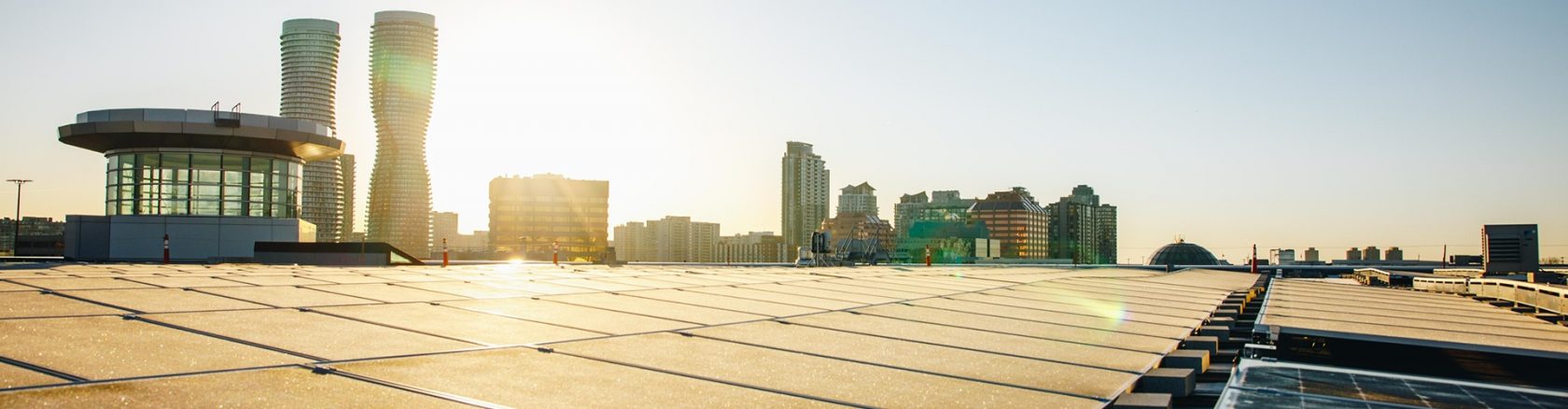 Solar panels installed on the rooftop generating clean energy with a skyline backdrop
