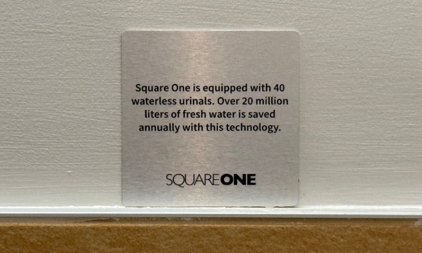 Water conservation signage highlighting waterless systems and efficient resource usage initiatives